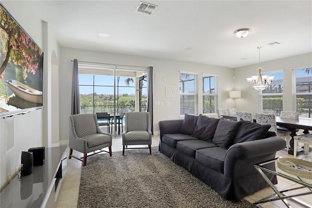 living room featuring light tile patterned floors and an inviting chandelier