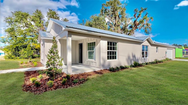 rear view of property with a yard and a patio