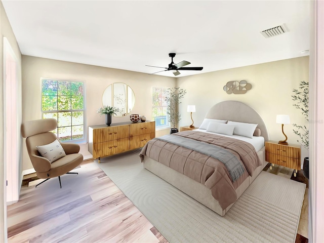 bedroom with ceiling fan and light wood-type flooring