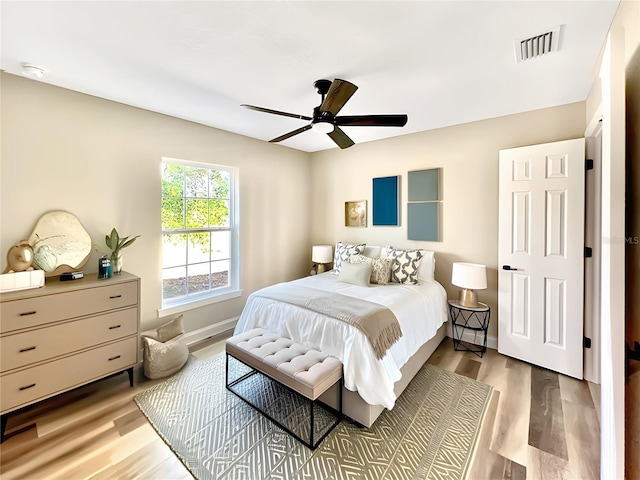 bedroom with ceiling fan and hardwood / wood-style floors