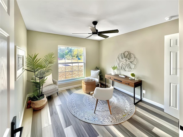 sitting room featuring ceiling fan and wood-type flooring