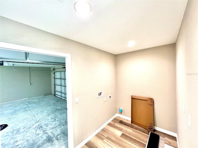 laundry room with light wood-type flooring and hookup for an electric dryer