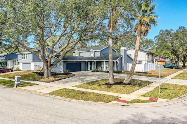 view of front of home with a front yard and a garage