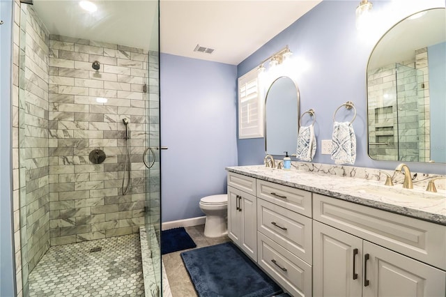 bathroom with a shower with door, toilet, and vanity