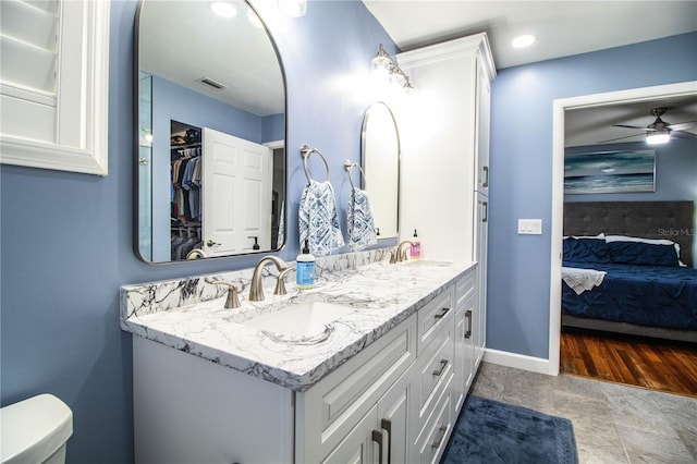 bathroom featuring ceiling fan, toilet, and vanity