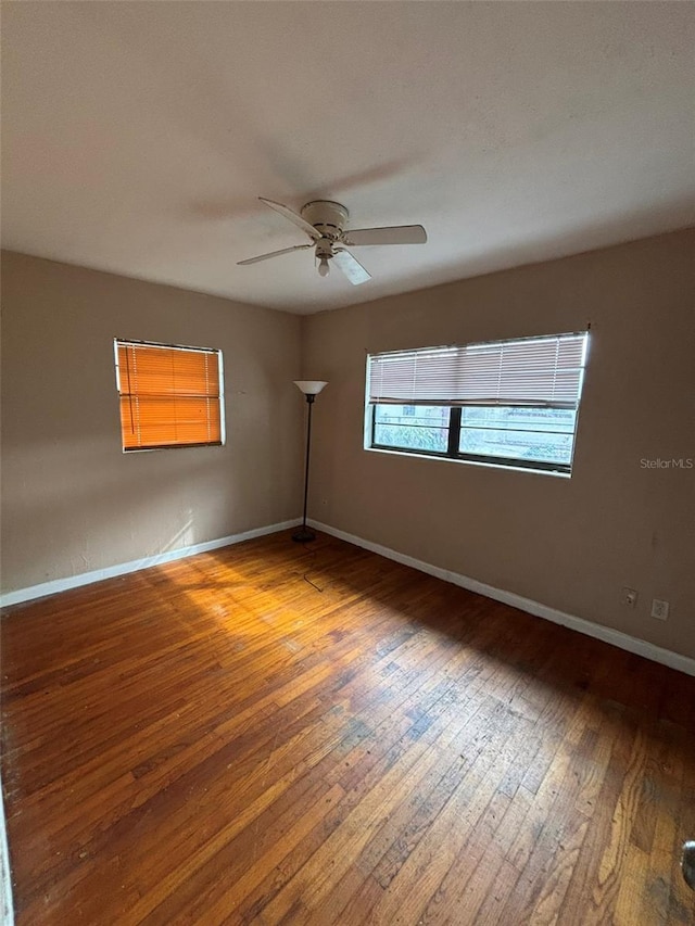 unfurnished room with ceiling fan and wood-type flooring