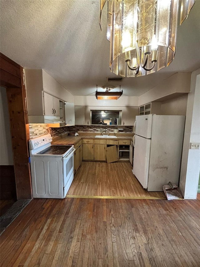 kitchen with white appliances, light hardwood / wood-style flooring, and a textured ceiling