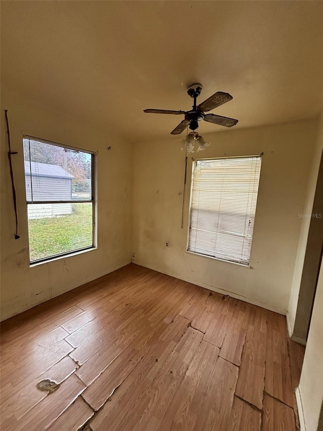 spare room featuring ceiling fan and light hardwood / wood-style floors