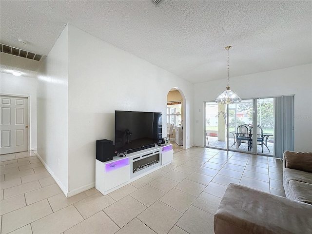 living room with a textured ceiling and light tile patterned floors