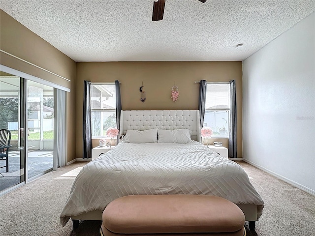 bedroom with light carpet, ceiling fan, access to exterior, and a textured ceiling