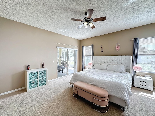 bedroom with a textured ceiling, ceiling fan, access to exterior, and carpet