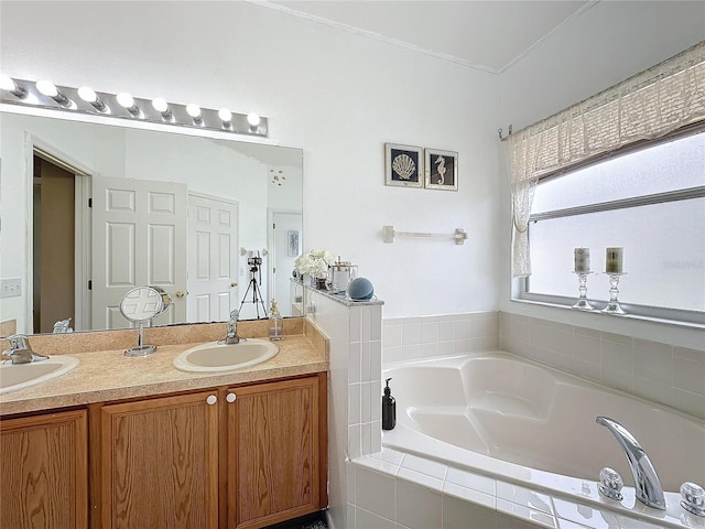 bathroom with tiled bath and vanity