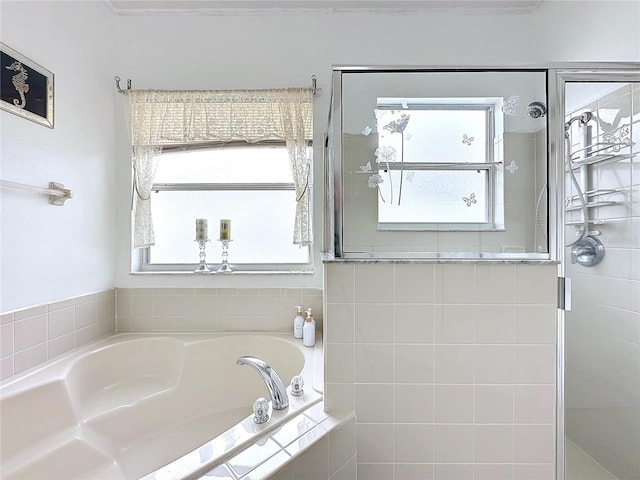 bathroom featuring a wealth of natural light and shower with separate bathtub