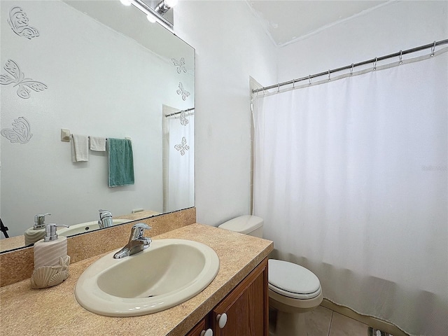 bathroom with toilet, tile patterned flooring, and vanity