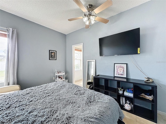 bedroom with a textured ceiling and ceiling fan