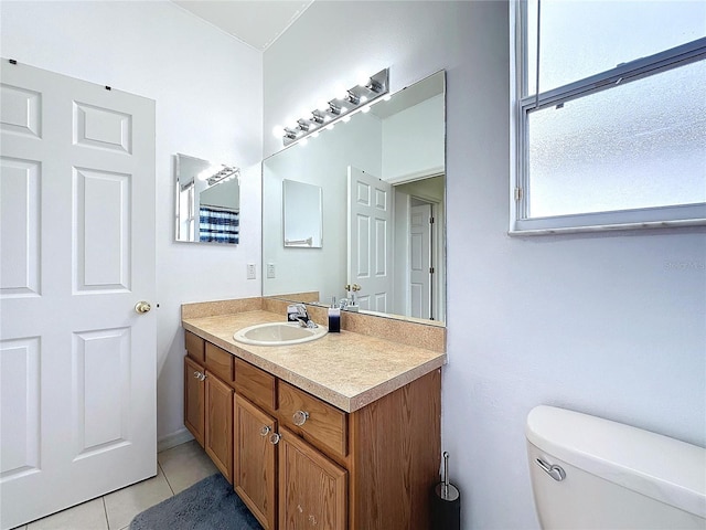 bathroom with tile patterned floors, vanity, and toilet