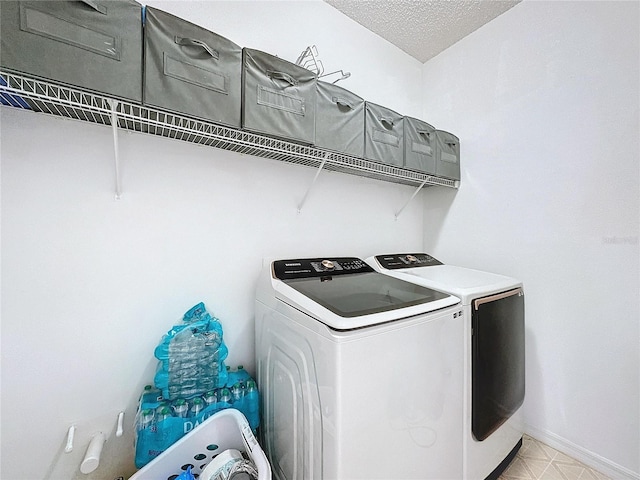 washroom with separate washer and dryer and a textured ceiling