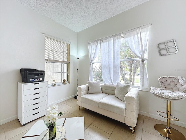 living room featuring light tile patterned floors and a textured ceiling