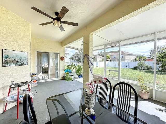 sunroom featuring ceiling fan