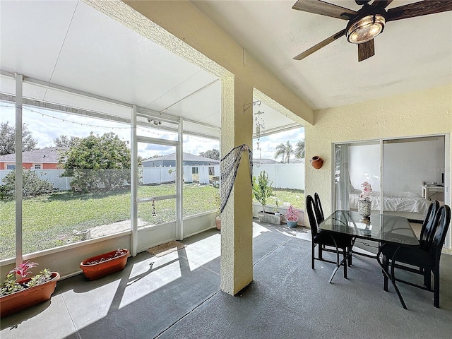 sunroom / solarium featuring ceiling fan