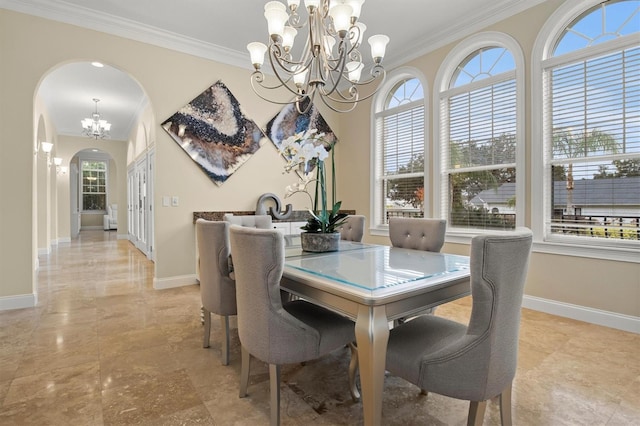 1665 Blue Heron Ln, Lakeland, FL 33813 - dining space featuring arched walkways, a chandelier, baseboards, and ornamental molding