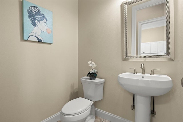 1665 Blue Heron Ln, Lakeland, FL 33813 - bathroom featuring baseboards and toilet