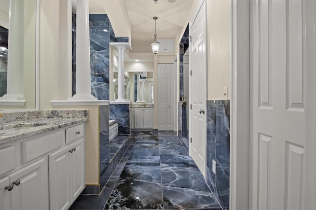 1665 Blue Heron Ln, Lakeland, FL 33813 - full bathroom featuring marble tiled floors, ornate columns, and vanity