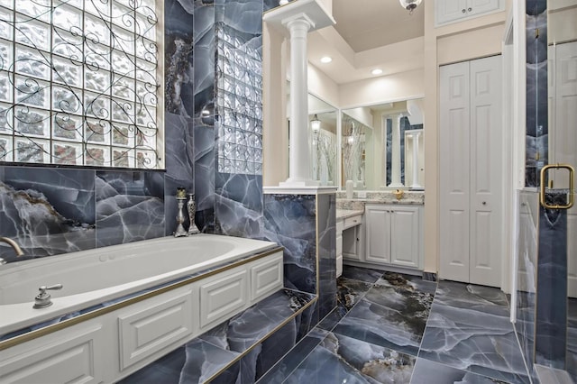 1665 Blue Heron Ln, Lakeland, FL 33813 - full bath featuring decorative columns, marble tiled flooring, a bath, and vanity
