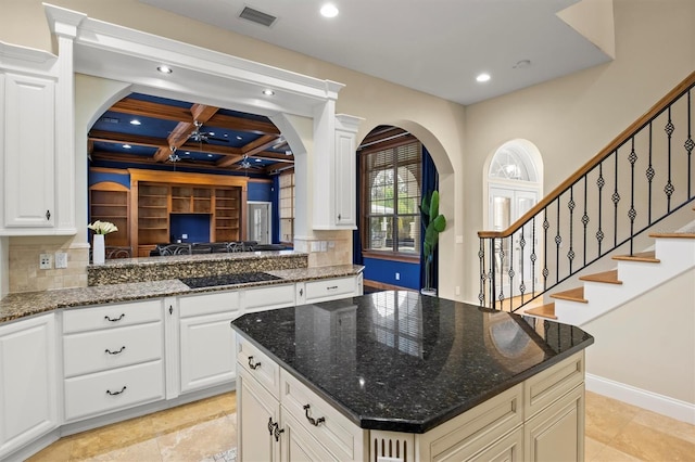 1665 Blue Heron Ln, Lakeland, FL 33813 - kitchen with arched walkways, black electric stovetop, recessed lighting, coffered ceiling, and a center island