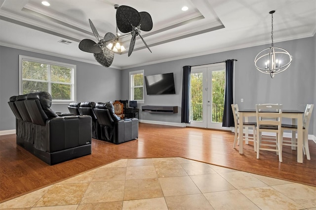 1665 Blue Heron Ln, Lakeland, FL 33813 - tiled living room with a chandelier, a raised ceiling, crown molding, baseboards, and ceiling fan
