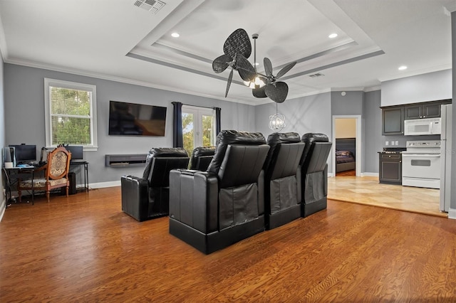 1665 Blue Heron Ln, Lakeland, FL 33813 - home theater room with wood finished floors, a raised ceiling, crown molding, ceiling fan, and recessed lighting