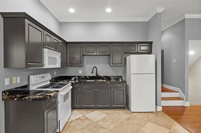 1665 Blue Heron Ln, Lakeland, FL 33813 - kitchen with white appliances, a sink, ornamental molding, dark stone counters, and recessed lighting