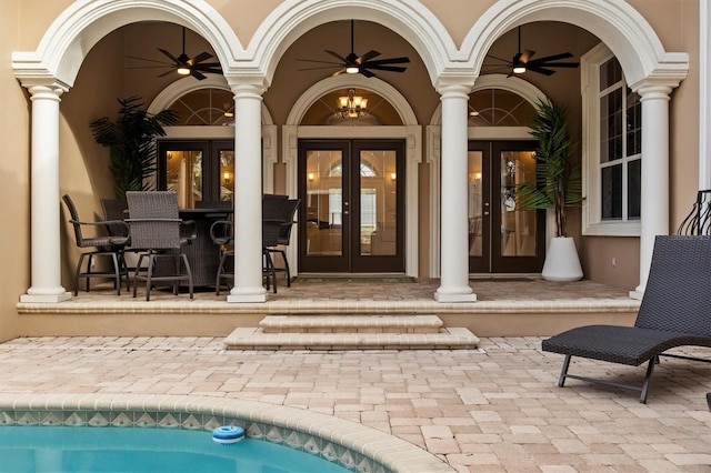 1665 Blue Heron Ln, Lakeland, FL 33813 - view of exterior entry with french doors, ceiling fan, stucco siding, a patio, and an outdoor pool