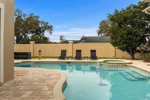 1665 Blue Heron Ln, Lakeland, FL 33813 - view of swimming pool featuring fence, a pool with connected hot tub, central AC, and a patio