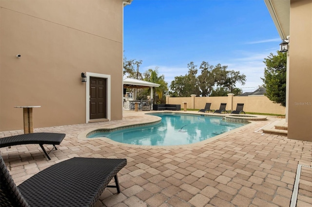 1665 Blue Heron Ln, Lakeland, FL 33813 - view of pool featuring a patio area, fence, a pool with connected hot tub, and a gazebo