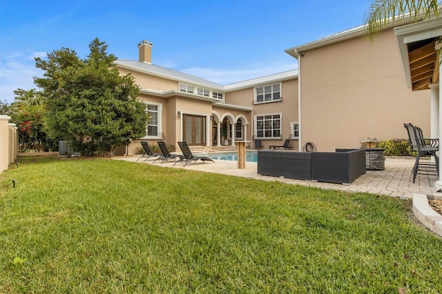 1665 Blue Heron Ln, Lakeland, FL 33813 - back of property featuring french doors, stucco siding, and a patio area