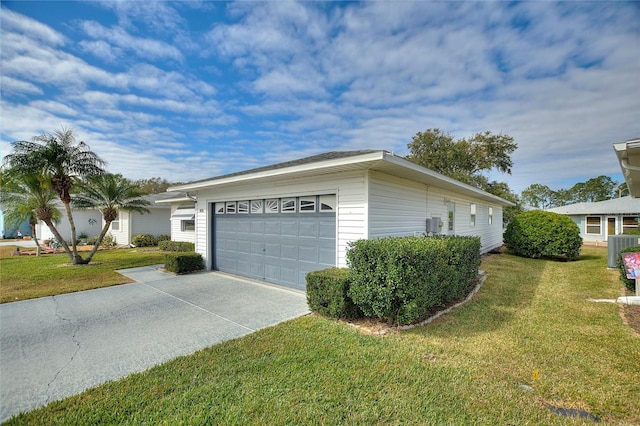 view of side of property featuring a garage, a yard, and central AC