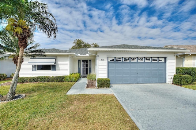 single story home featuring a front lawn and a garage