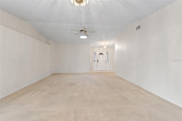 carpeted empty room featuring ceiling fan and vaulted ceiling