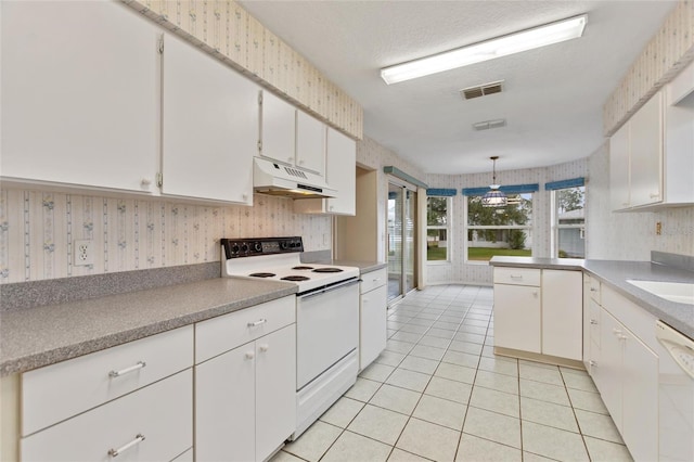 kitchen featuring light tile patterned floors, white cabinetry, decorative light fixtures, white appliances, and a textured ceiling