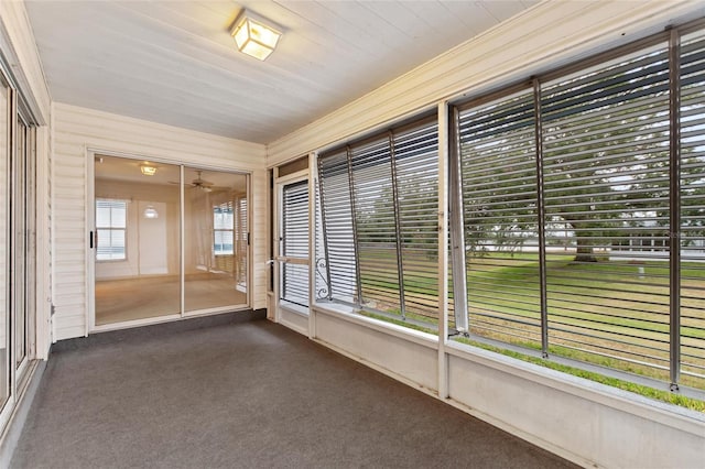 unfurnished sunroom with ceiling fan and a healthy amount of sunlight