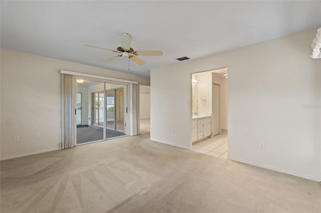 spare room with ceiling fan and light carpet