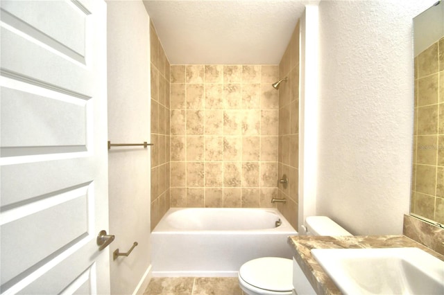 full bathroom with toilet, a textured ceiling, tiled shower / bath, and sink