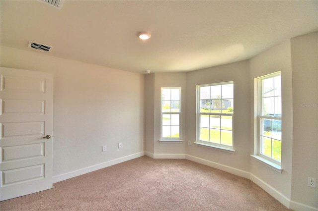 empty room featuring light colored carpet