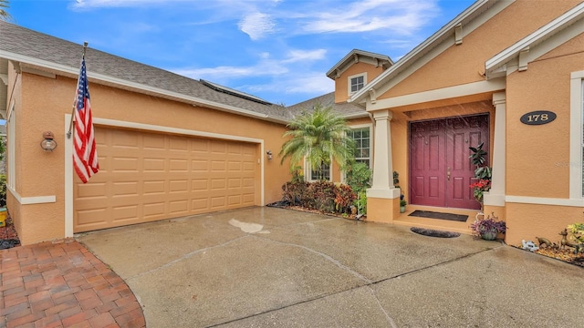 view of exterior entry featuring a garage