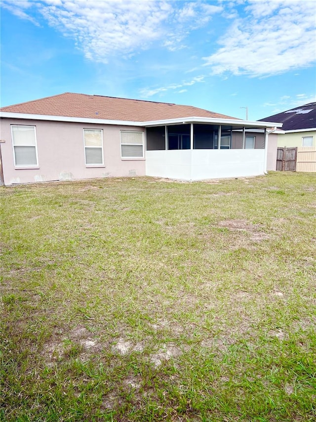 rear view of property with a yard