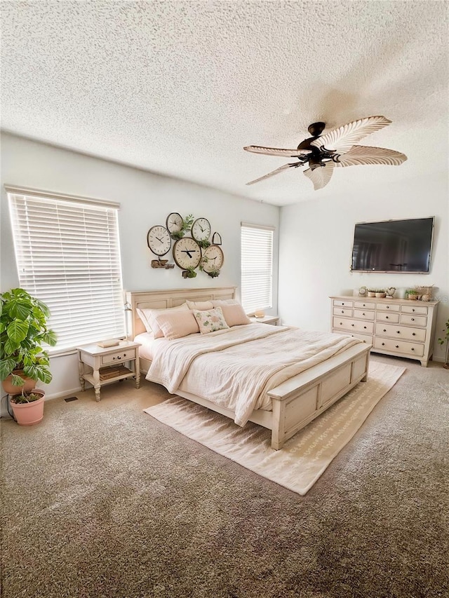 unfurnished bedroom featuring light carpet, ceiling fan, and a textured ceiling