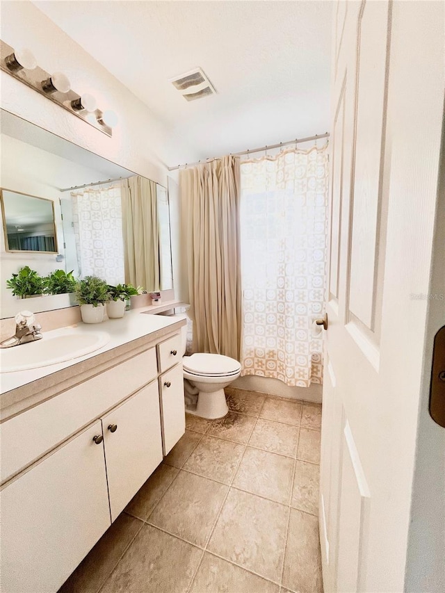 bathroom featuring vanity, curtained shower, tile patterned floors, and toilet