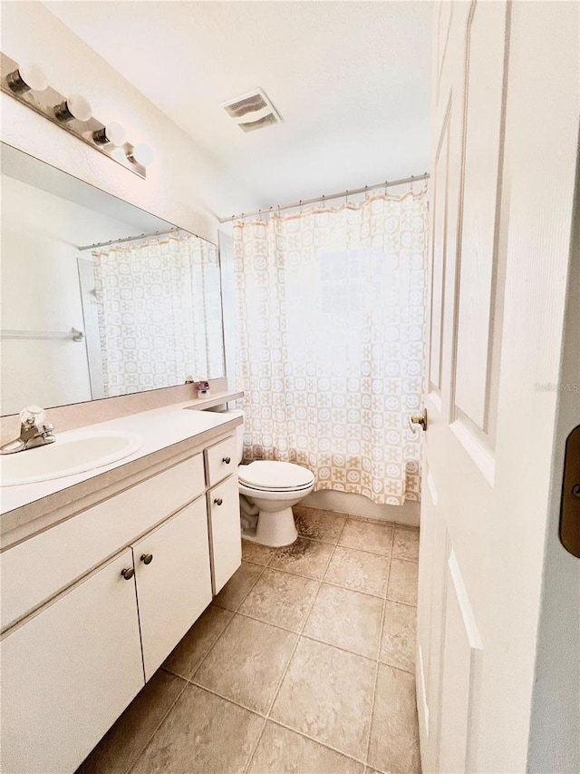 bathroom with vanity, toilet, and tile patterned flooring