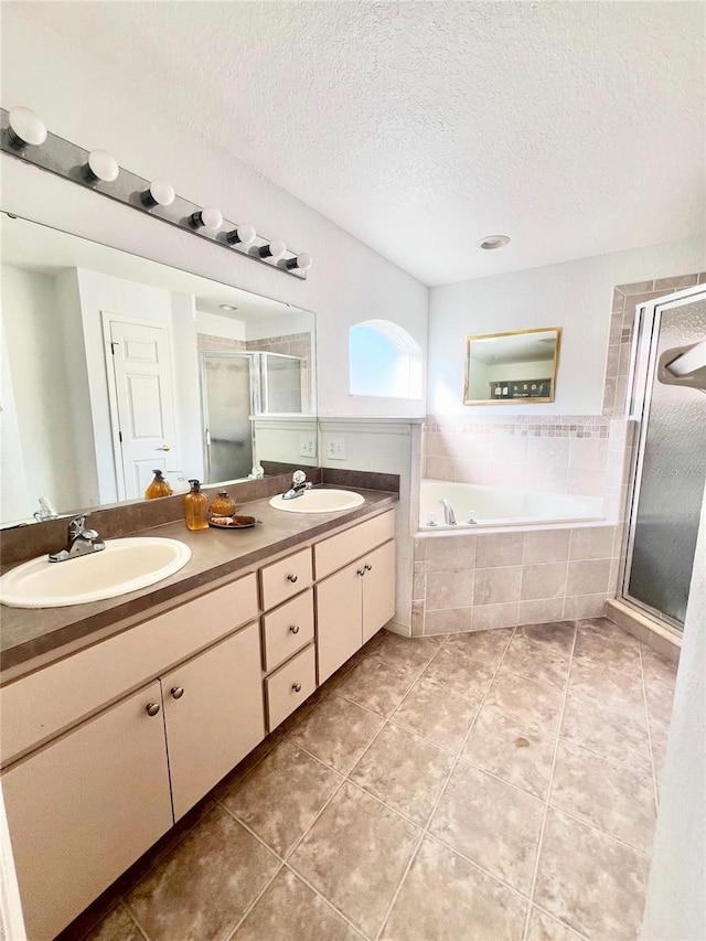 bathroom with vanity, tile patterned floors, independent shower and bath, and a textured ceiling